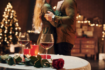 Standing and dancing. Young lovely couple have romantic dinner indoors together