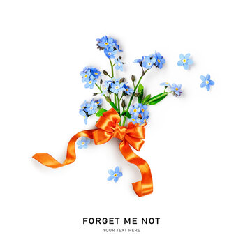 Forget me not spring flowers with bow ribbon on white background