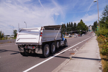 Truck (dumper) in urban traffic. A city in the USA. State Washington.