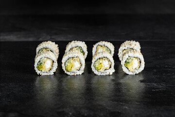 Japanese food sushi rolls uramaki    black background close-up for menu 