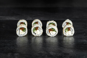 Japanese food sushi rolls uramaki    black background close-up for menu 