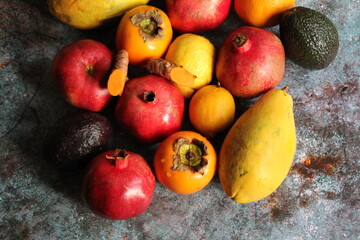 red pomegranates, papaya seeds, fruit full of juice, vitamins, orange papaya, colorful fruit, apple, fresh turmeric cut in half