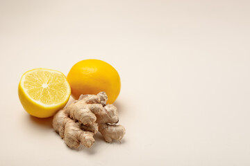 Close-up of ginger and lemon on a light beige background with copy space