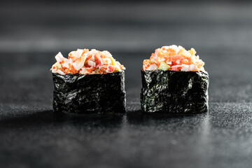 Set sushi gunkan made from tuna, salmon, sea comb, perch, shrimp and smoked eel on black...