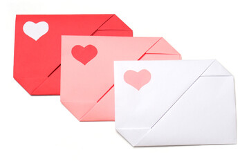 Red, pink, white paper envelopes with colored hearts on white background isolated. Love,...