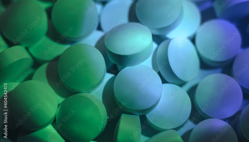 Poster pills or drugs in a package under neon light. beautiful background pattern for design.