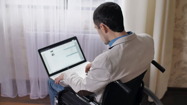 Disabled man working on laptop