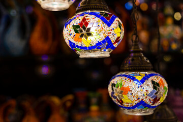 Traditional handmade multicolor Turkish, Moroccan, Arabian lamps hanging with nice blurred...