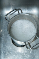 Pot in sink with sudsy rinse water