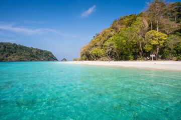 White sand beach under clear sky at tropicana