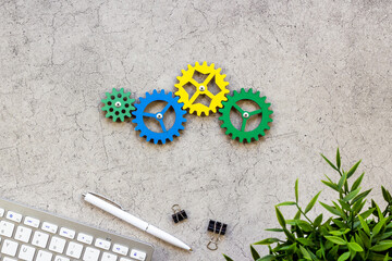 Teamwork and collaboration concept. Working gears on working place, ofiice table