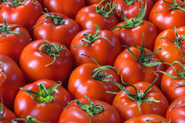 Vegetable background from juicy and ripe tomatoes.
