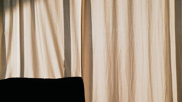 Silhouette Of A Man Hanging Out The Laundry. Homework. Drying Fresh Laundry In The Sun. Contrast Shadows On A Sunny Day. Shadow Of A Man Against The Background Of White Curtains. Dryer For Clothes.