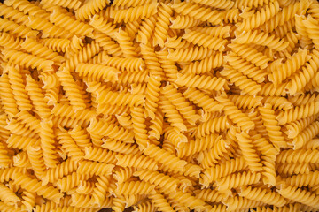 Close-up raw pasta background. Spiral Wheat Pasta