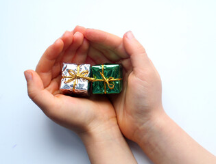 small gift boxes in child's hands