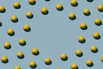 Creative fresh lemon pattern on blue background. Flat lay concept with copyspace