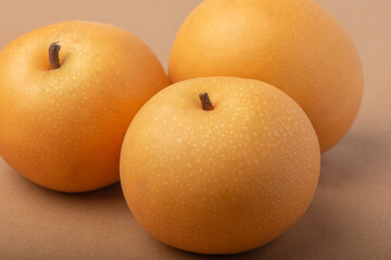 Snow pear or Nashi pears on white background,  Closeup of Asian yellow pear fresh fruit isolated on brown  background.