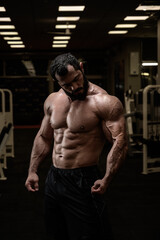 Fototapeta na wymiar muscular bearded man in sport bodybuilding night fitness club gym