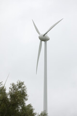 Wind turbines field in a stormy day with strong wind and rain. Wind farm eco field. Green ecological power energy generation.	