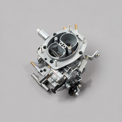 Car carburettor for internal combustion engine for mixing air with a fine spray of liquid fuel on gray background, side view. Automotive parts.