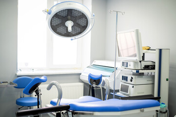 sterile operating room of a gynecologist. Blue gynecological chair. Medical procedures, operations