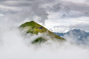 panorama view with the top of mount Fellhorngipfel in Germany among heavy clouds