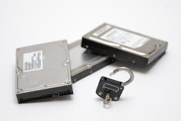 Computer hard disks and open metal padlock symbolizing concept for encrypted data, cyber security...
