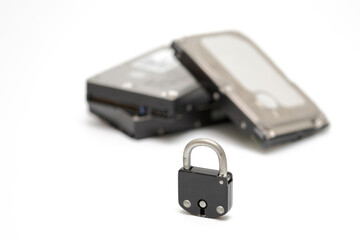 Computer hard disks and metal padlock symbolizing concept for encrypted data, cyber security on white background