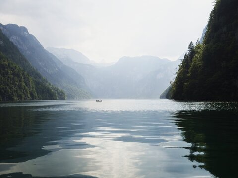 Panorama wooden rowing boat on alpine mountain lake Konigssee Koenigssee King Schonau Berchtesgaden Bavaria Germany alps
