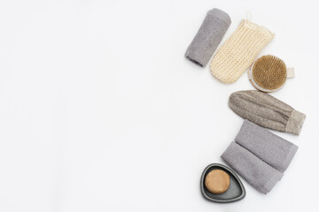 Spa still life zero waste background. Set for body care with space for text. Soap, cotton towel, washcloth for bath, wooden hairbrush.
