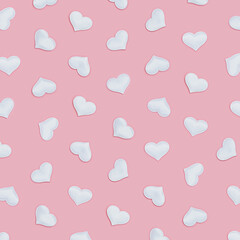 Pattern from white hearts, symbols of love on pink fon. Holiday background for Valentines Day. Love concept. Plain colored. Minimal style.