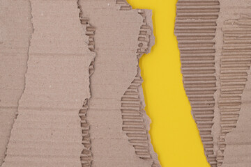 Pieces sheets of old kraft cardboard, the texture torn packaging box on a yellow background