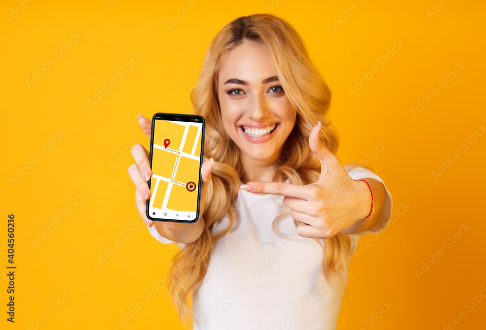 Poster cheerful woman pointing on smartphone with gps navigation application on screen
