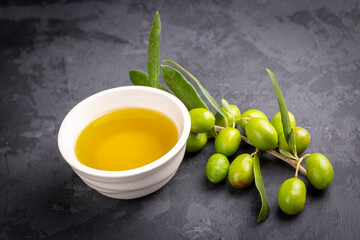 Green fresh olives and olive oil