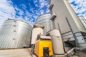 Modern up to date factory with steel grain elevators. Selective focus. View from below.