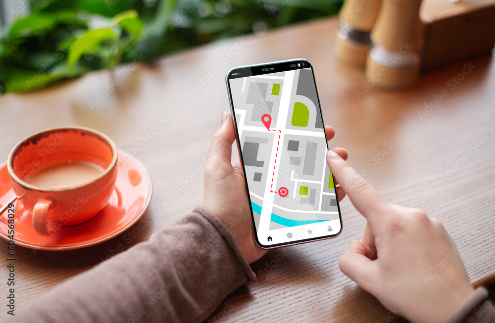 Poster unrecognizable woman using online maps application on smartphone while sitting in cafe