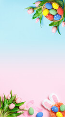 Vertical Easter composition on a pink and blue background. Top view banner with copy space flat lay greeting card.