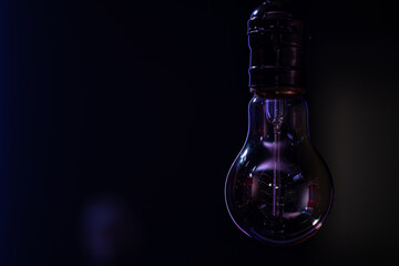 Close up of a non-burning lamp on a blurred dark background.