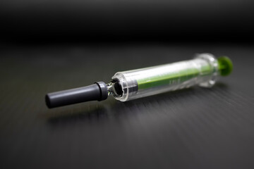 Syringe on a black background