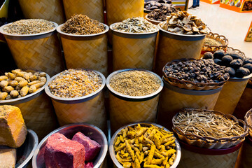Variety of colorful Arabic spices and herbs on the arab street market stall. Dubai Grand Spice Souk, United Arab Emirates.