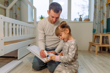 Father with daughter fixing the drawer of kids bed