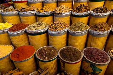 Variety of colorful Arabic spices and herbs on the arab street market stall. Dubai Grand Spice Souk, United Arab Emirates.