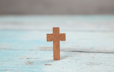 wooden cross on wooden table