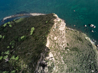 Seascape Aerial Shot saddle of the devil (sella del diavolo) with calm sea in Caglairi - Sardinia.
