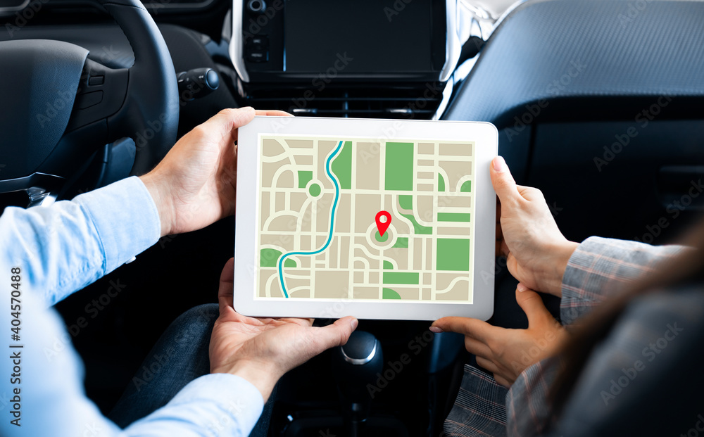 Poster gps application. couple using digital tablet with opened navigation application in car