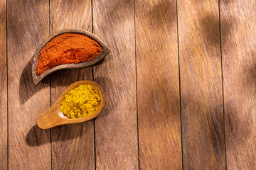 Organic curry and paprika spices - Wooden background