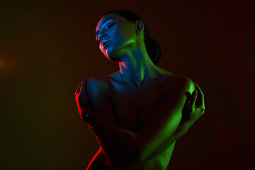 Female silhouette, beautiful woman in color lights