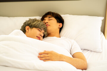 same sex couple lovers LGBTQ lying on bed together 