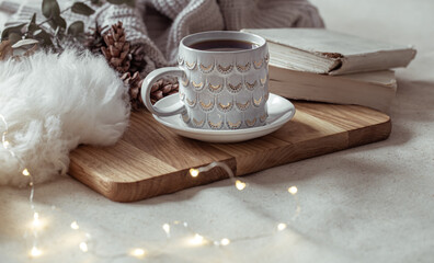 Fototapeta na wymiar A cozy composition with a beautiful cup and decor details.