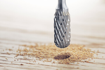 drill bit or milling cutter make hole in wooden oaks plank